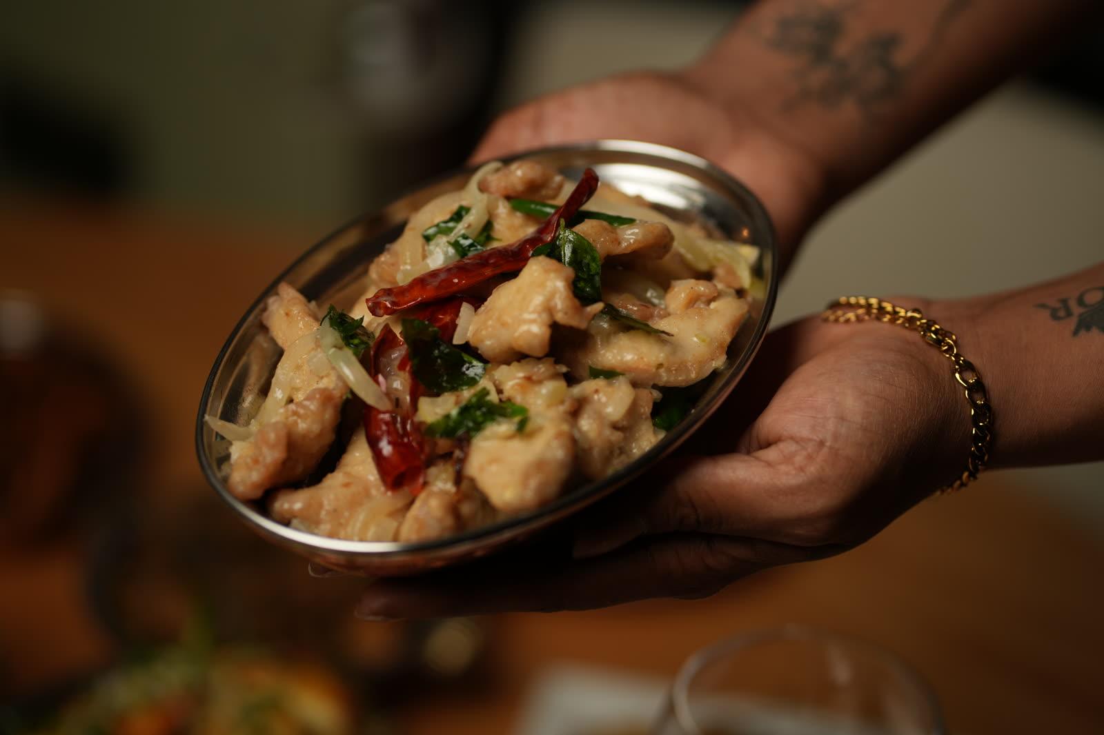 Butter chicken — chargrilled chicken in a glossy tomato and butter gravy, garnished with coriander
