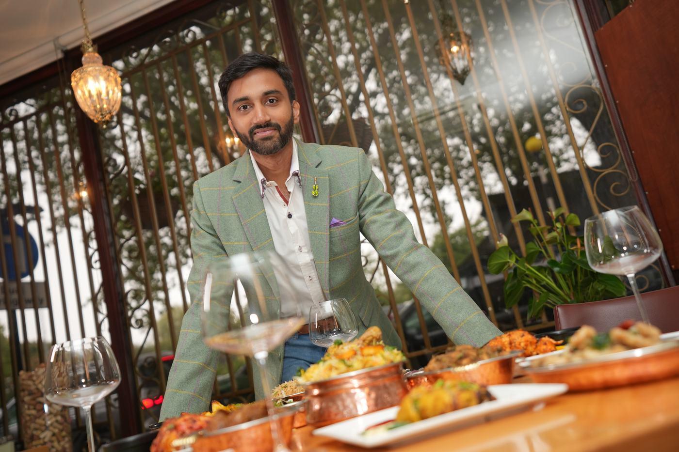 A member of the Aara family at a table laid with dishes